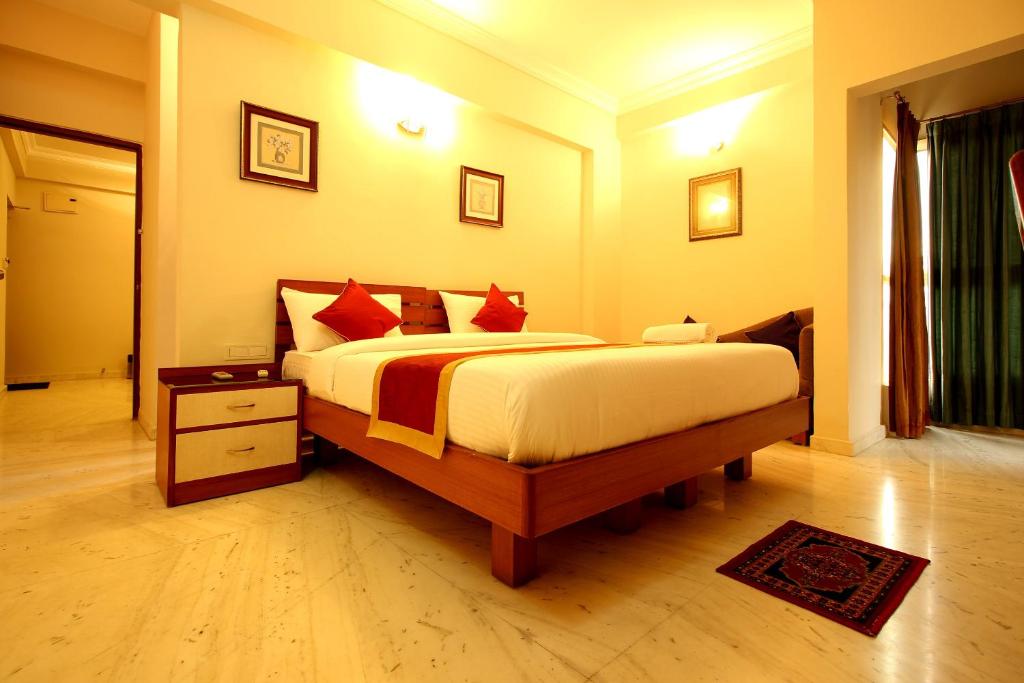 een slaapkamer met een groot bed in een kamer bij OYO 6825 New Crescent Citadel in Bangalore