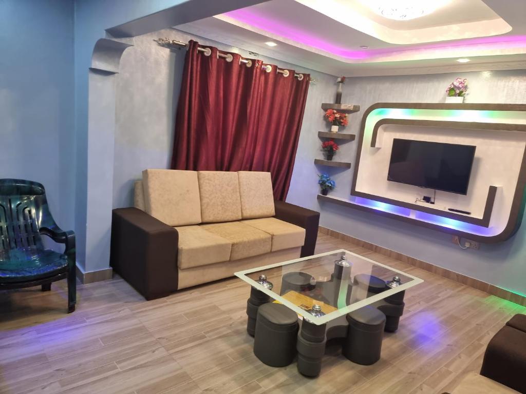 a living room with a couch and a tv at Finland in Migori