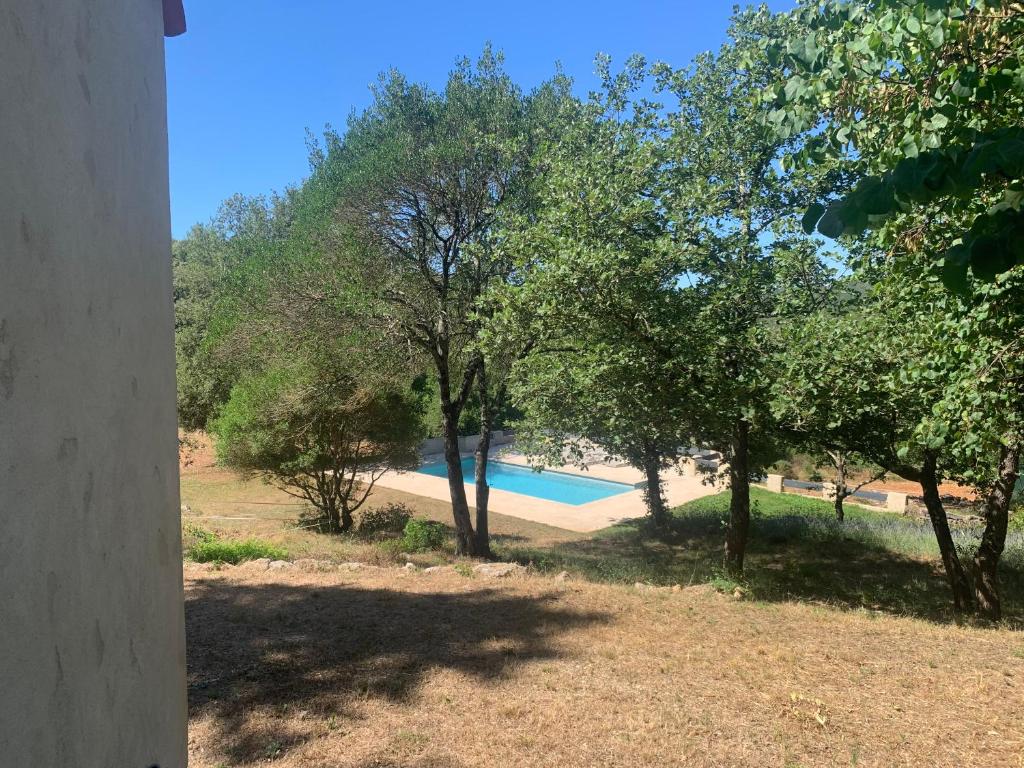 a view of a swimming pool with trees at Guest House in Montauroux