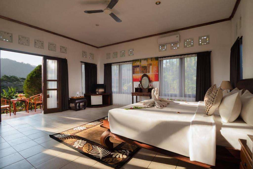 a bedroom with a large bed in a room at The Kanjeng Signature Sidemen in Sidemen