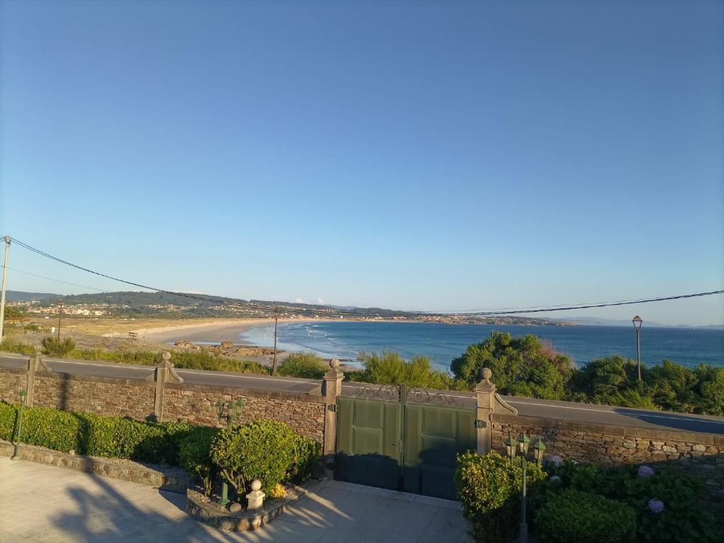 a view of the beach from a house at Chalet con vistas al mar en la playa de A Lanzada in O Grove