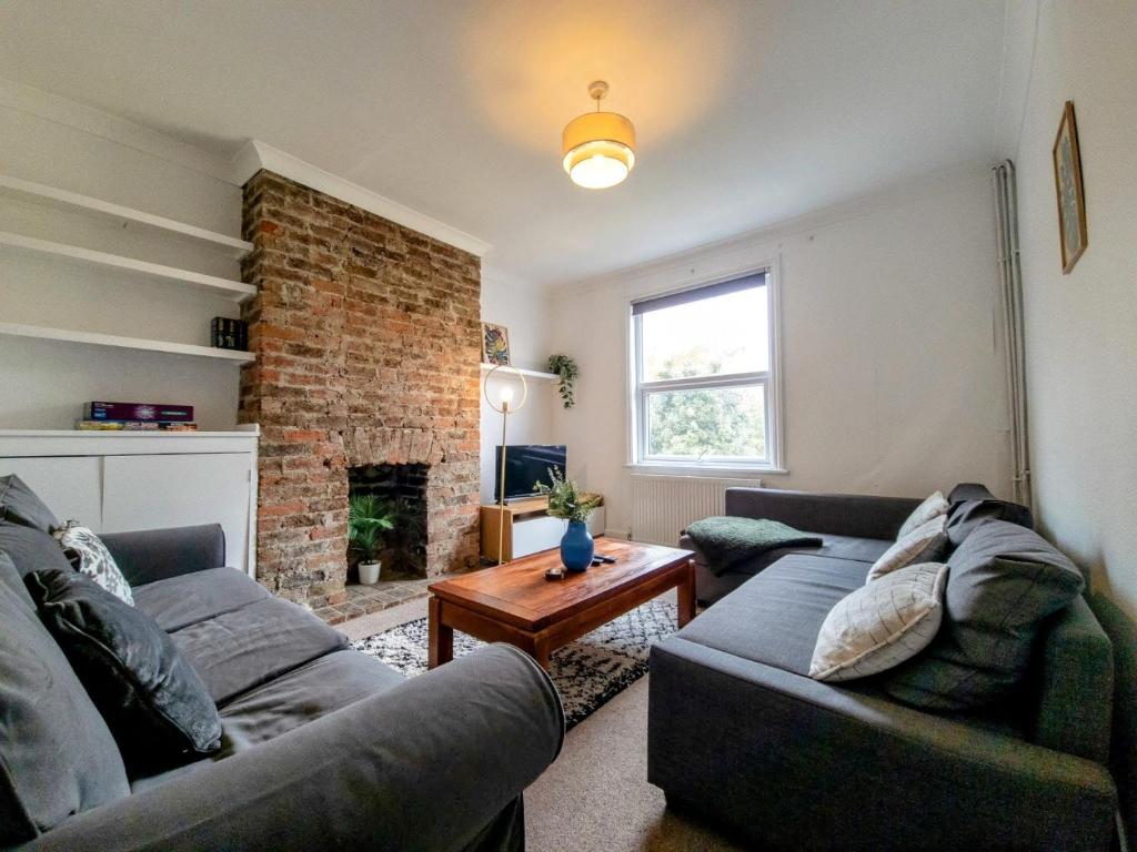 a living room with two couches and a fireplace at Peaceful 4 bed townhouse in Brighton & Hove