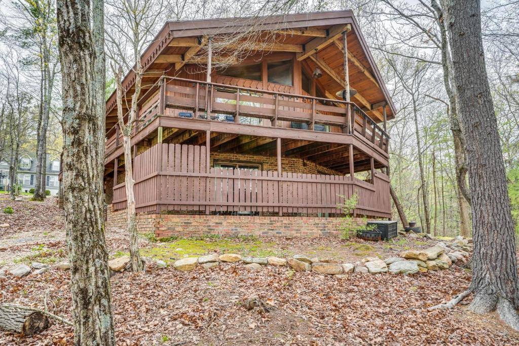 a large wooden house in the woods with trees at Treehouse-Style Cabin, 1 Mi to Massanutten Resort in McGaheysville
