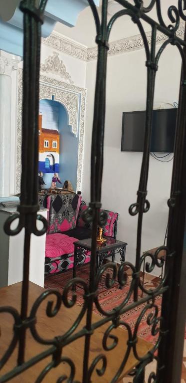 a living room with a couch and a bed at Blue heart in Chefchaouen