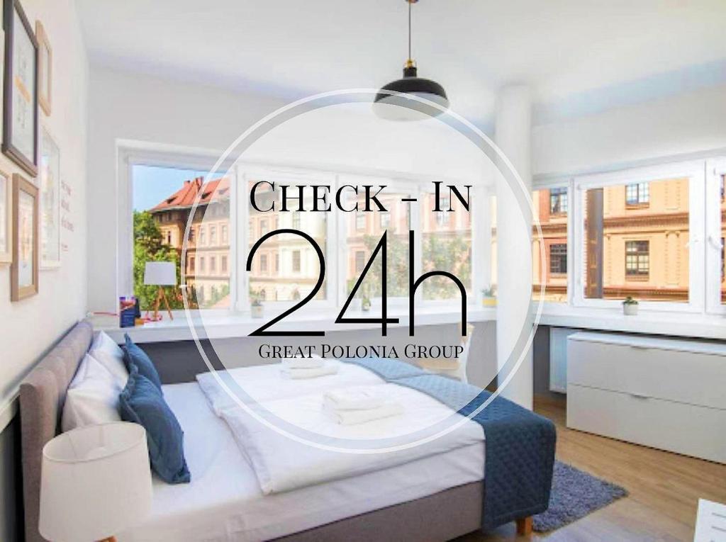 a sign that reads check in in a bedroom at Great Polonia Kraków City Center in Kraków
