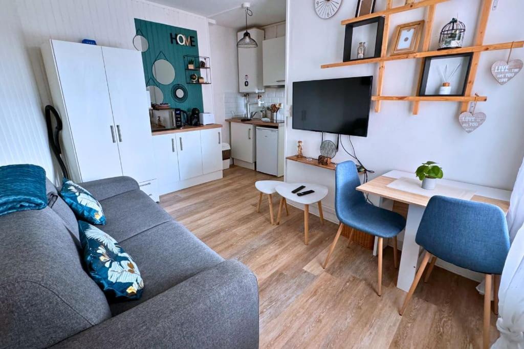 a living room with a couch and a table at Studio chic & cosy, RER D, Orly 15min in Villeneuve-Saint-Georges