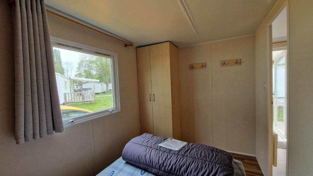 Postel nebo postele na pokoji v ubytování EGELE MOBILE-HOME prox Europapark et Rulantica
