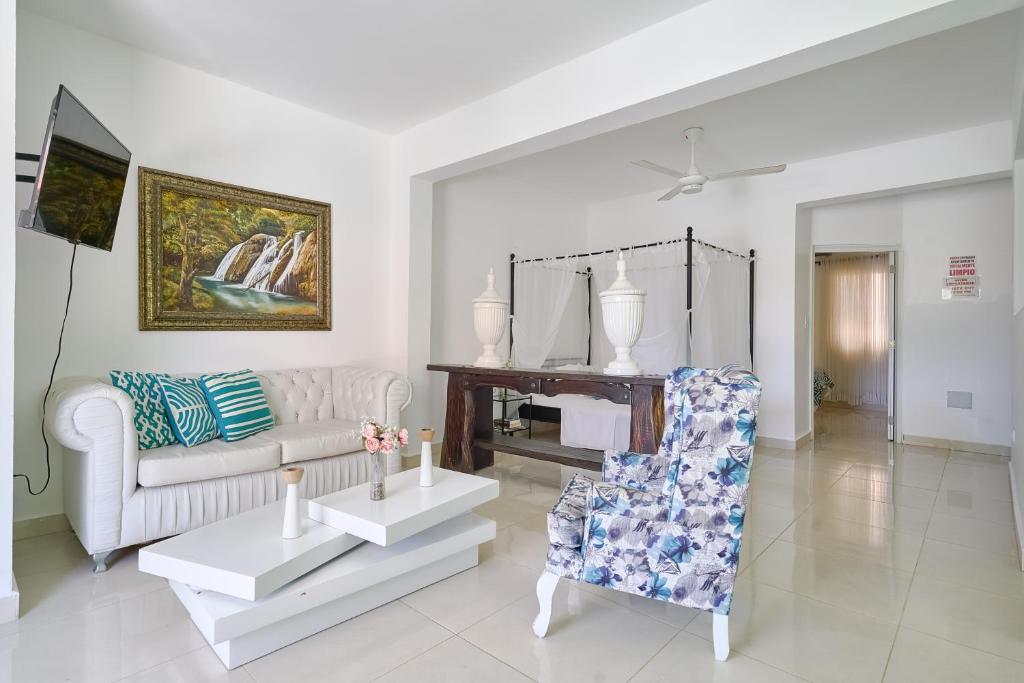 a living room with a couch and a chair at Red House on the beach in Punta Rucia