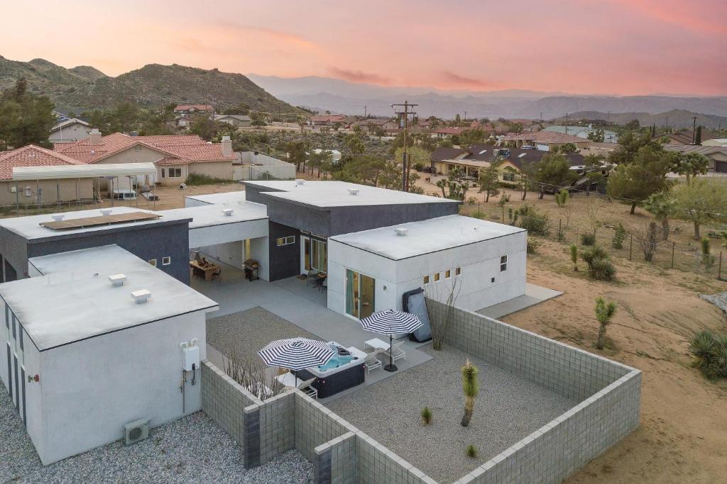 an aerial view of a house in the desert at Ishan by AvantStay Designer Joshua Tree Oasis in Yucca Valley