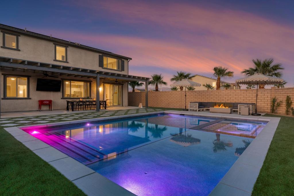 a swimming pool in front of a house at Desert Eden by AvantStay 6BR w Ensuite Backyard Oasis w Pool Hot Tub in Coachella