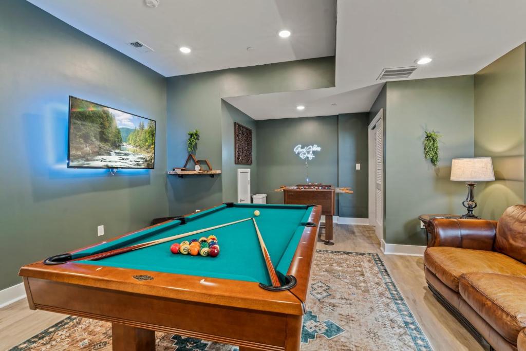 a living room with a pool table and a couch at Luxury Townhome 2 Car Garage and Decks 2 Billiards Room in Philadelphia