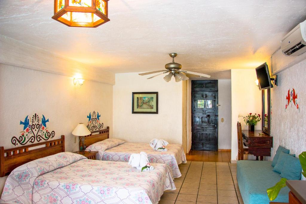 Postel nebo postele na pokoji v ubytování Vallartasol Hotel