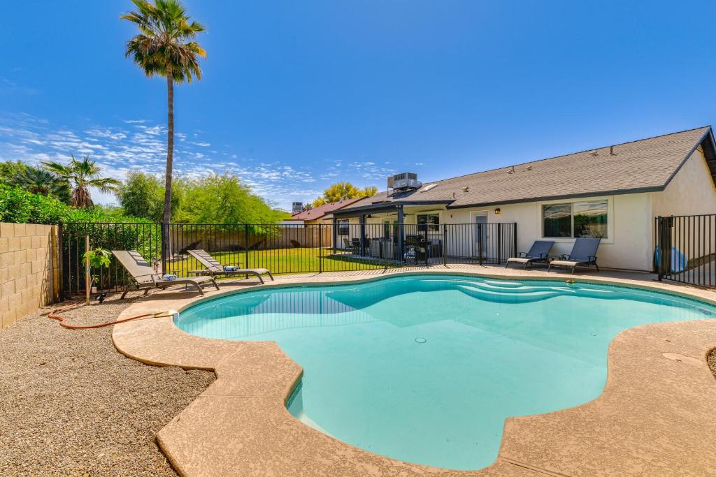 a swimming pool with two chairs and a house at Spacious Desert Oasis in Mesa with Private Pool! in Mesa