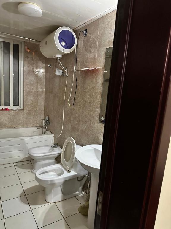 a bathroom with two toilets and a sink at Maqueda 2. Sanjo in Malabo