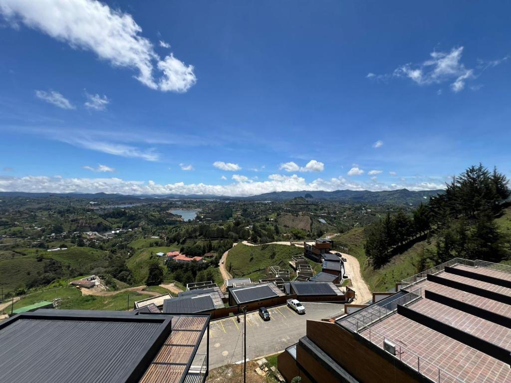 a view of a town with solar panels on a hill at Montecielo Hosting in Guatapé