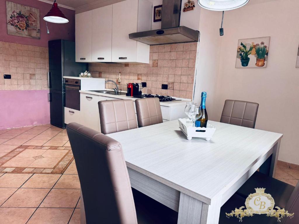 a kitchen with a white table with chairs and a counter top at Casa belvedere in Anzio