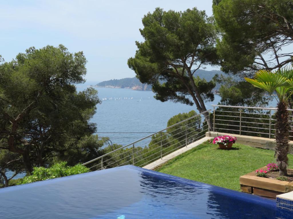 a swimming pool with a view of the water at Blueview Villa in Llafranc