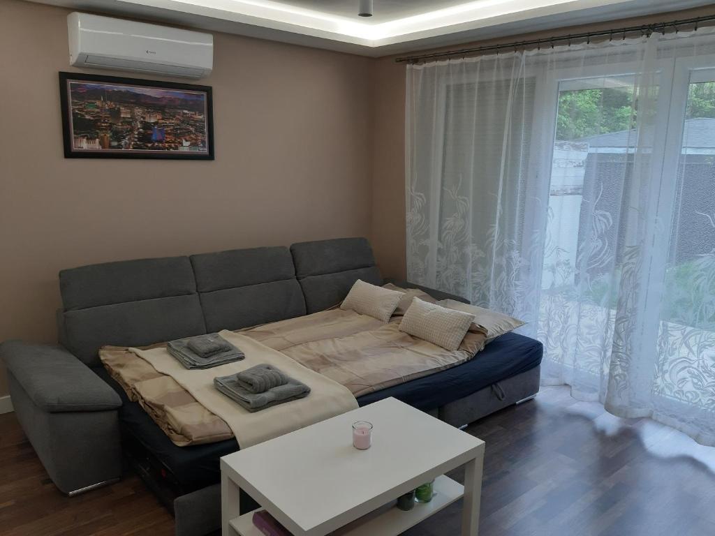 a living room with a couch and a table at Cozy apartment close to the airport in Budapest