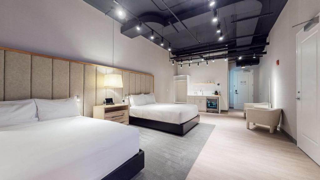 a hotel room with two beds and a kitchen at Studio 154 Luxury Hotel in Nashville