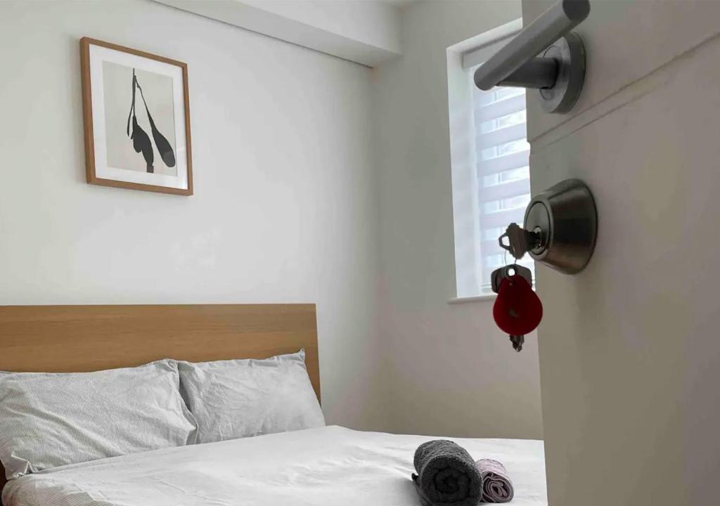 a bedroom with a bed with a lamp and a window at Welcome To Your Home in London