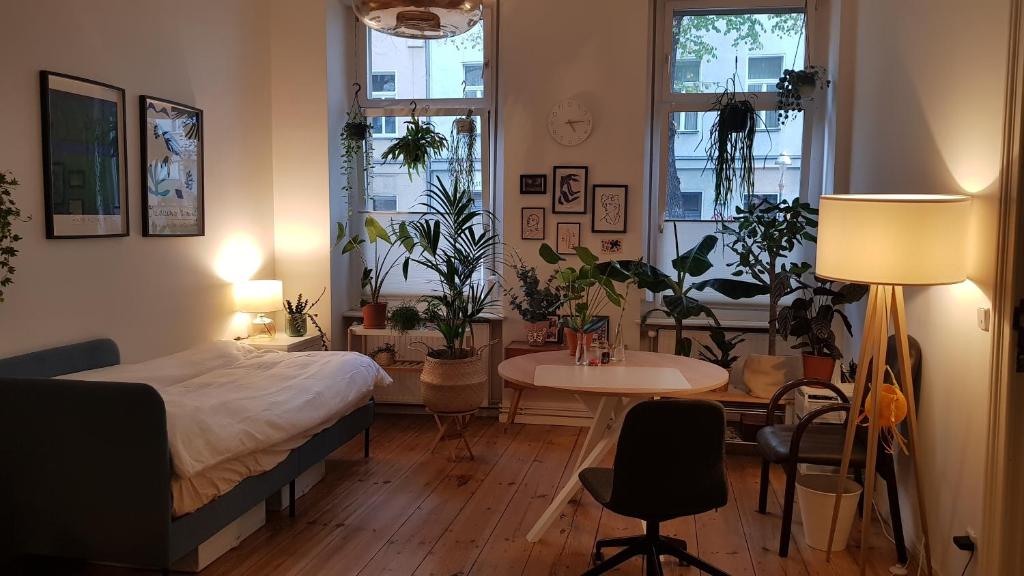 a bedroom with a bed and a table and chairs at Cozy room in Neukölln , Kreuzberg in Berlin