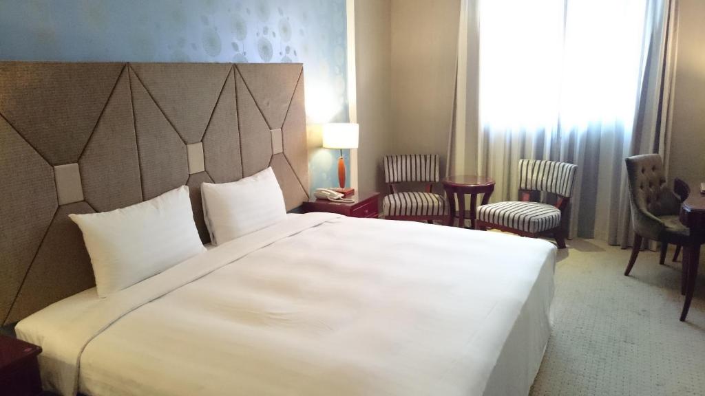 Postel nebo postele na pokoji v ubytování MRT Hotel