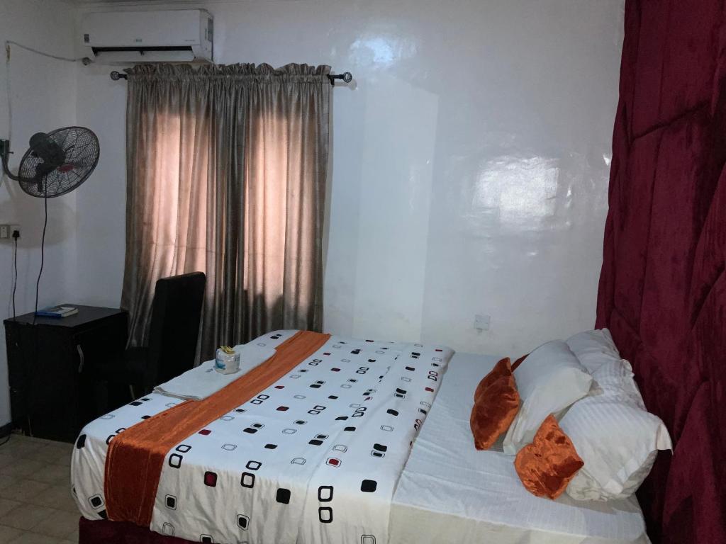 a bedroom with a bed with white sheets and pillows at BLUE MOON HOTELS VICTORIA ISLAND in Lagos