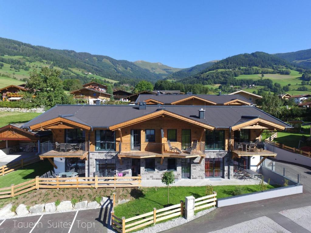 an aerial view of a house with mountains in the background at Luxury Tauern Suite Walchen Kaprun 1 in Piesendorf