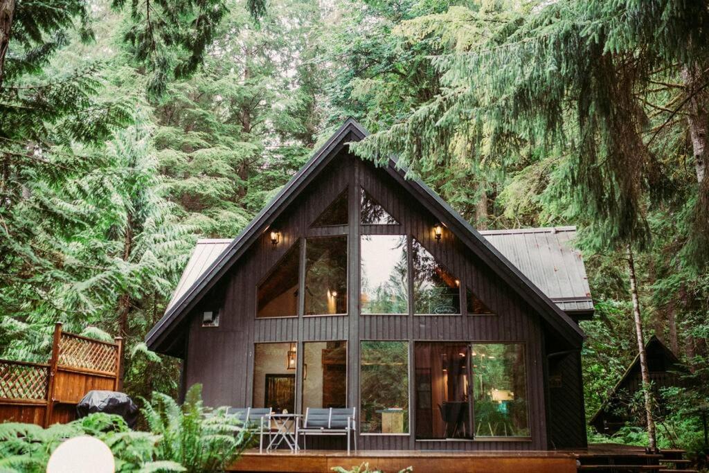 a house in the woods with a large window at Mountainview Lodge in Deming