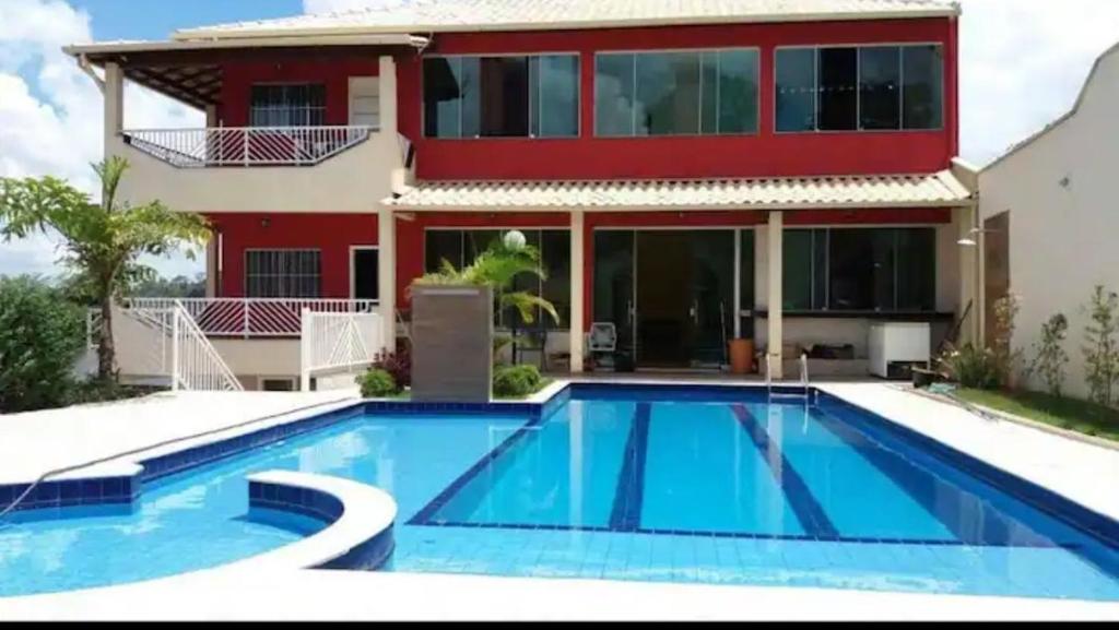 a house with a swimming pool in front of a house at SITIO AMANHECER VERDE in Contagem