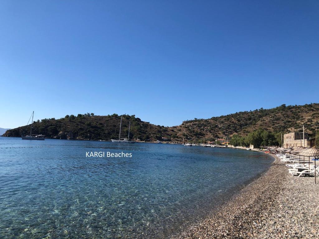 une plage avec un panneau indiquant les plages de koko dans l'établissement Villa Carian Trail Datca , Kargi bay , close to beach, à Datça