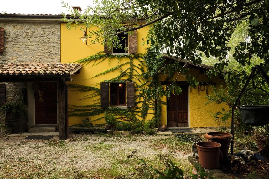 a yellow house with a window and a door at B&B Ca'del Gallo in Novafeltria