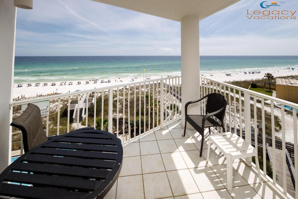 a balcony with chairs and a view of the beach at SC 601 - Beachfront Condo With Amazing Views! in Fort Walton Beach