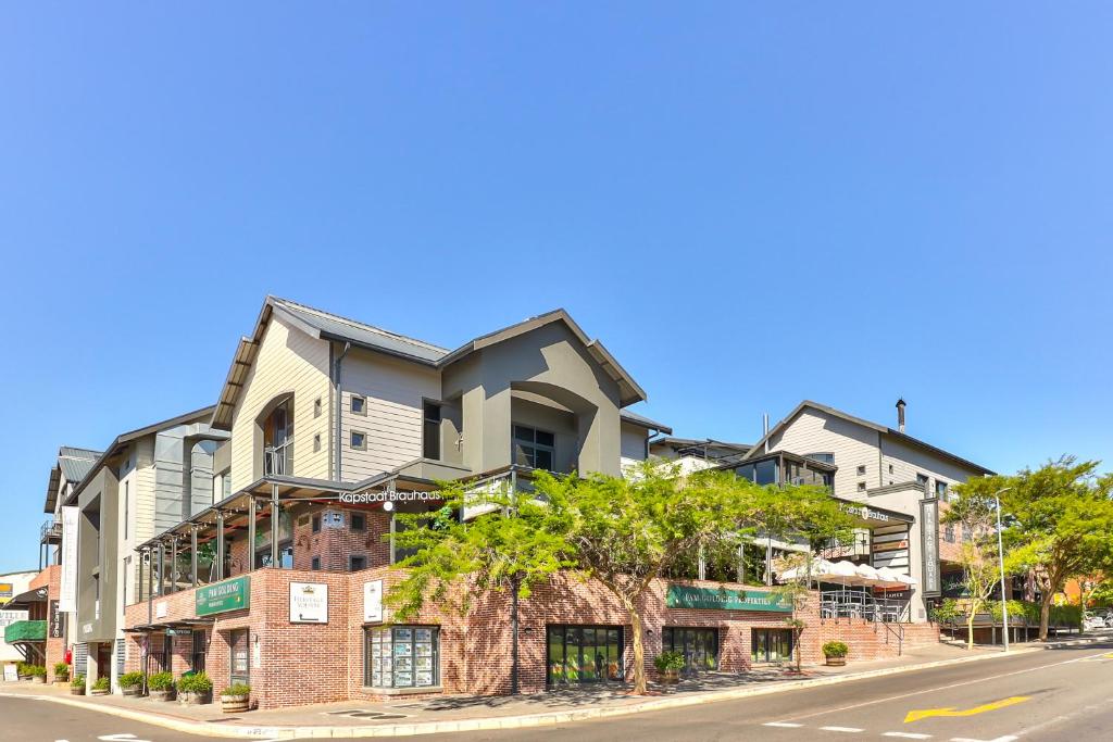 a building on the side of a street at Heritage Square Apartments in Durbanville