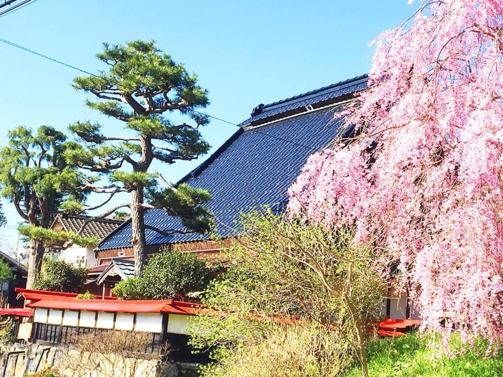 un arbre aux fleurs roses devant un bâtiment dans l'établissement Kyoto - House - Vacation STAY 85184, à Shūzan