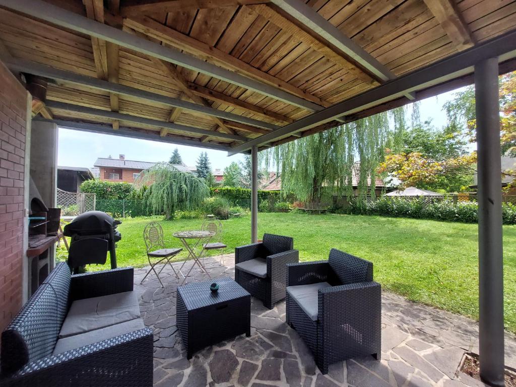 a patio with couches and a table and chairs at R24, ROSE house in Ljubljana