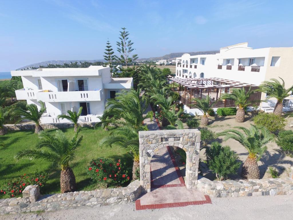 a resort with a stone bridge in front of a building at Kalimera Mare in Kardamaina
