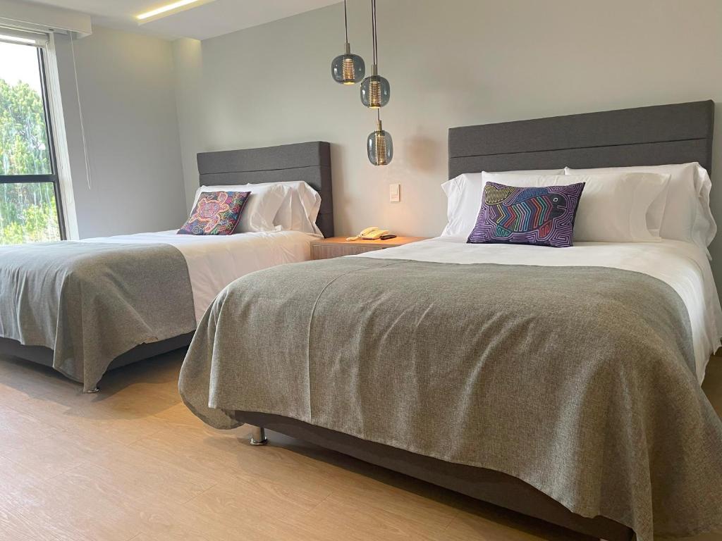 Postel nebo postele na pokoji v ubytování Hotel Parque 97 Suites