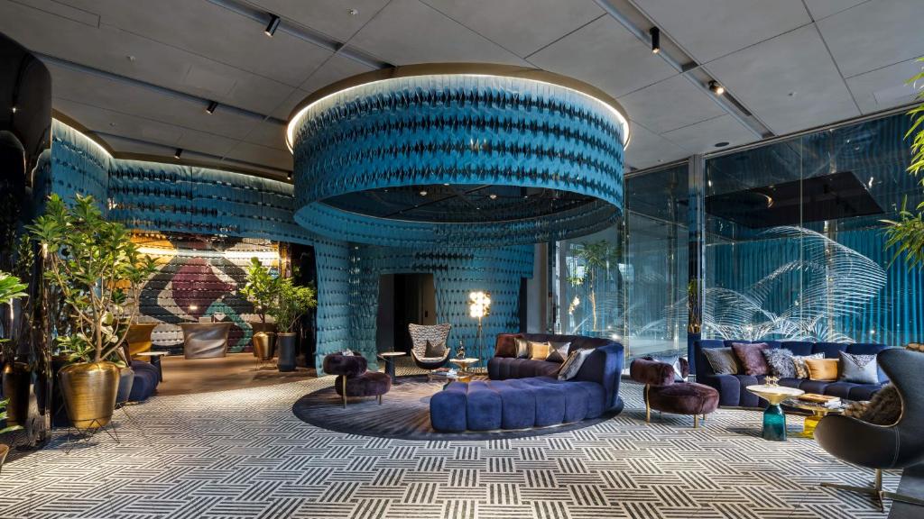 a lobby with blue walls and a blue ceiling at Mercure Tokyo Hibiya in Tokyo