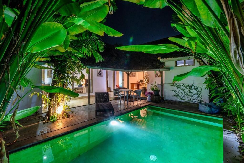 a swimming pool in a house with plants at Legian Beach 3 Bedroom Villa in Legian