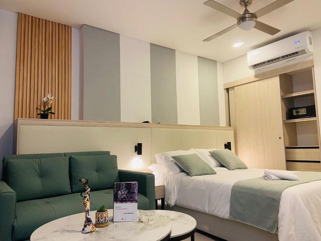a hotel room with two beds and a couch at Hotel porto horizonte suite 329 Santa Marta in Playa Bello Horizonte