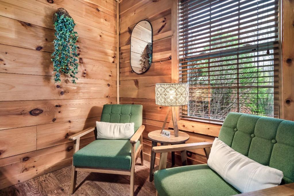 two chairs and a lamp in a room with wooden walls at Mama Bear's Moonshine Ridge in Gatlinburg