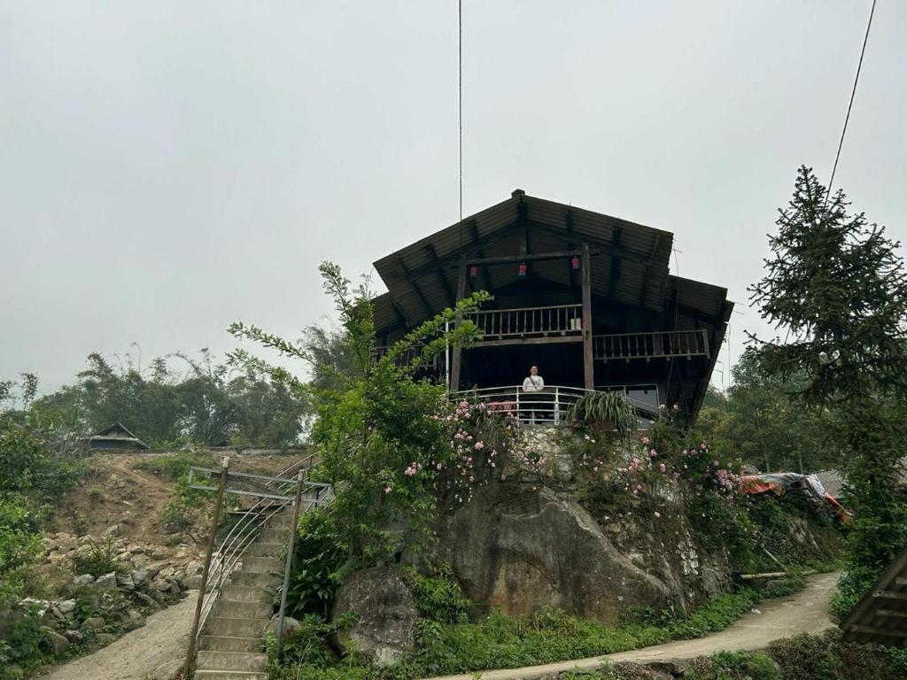 a house on a hill with a person in it at Miss Ann Homestay in Sa Pả