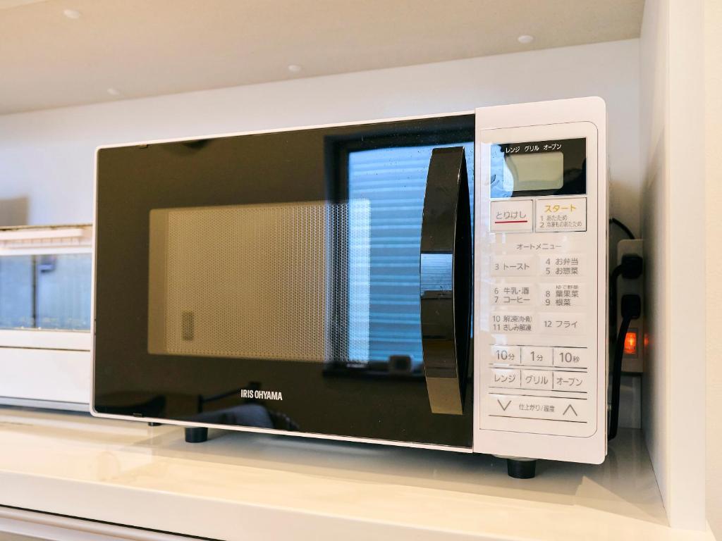 TV a/nebo společenská místnost v ubytování Kokoyui Guesthouse Shingu