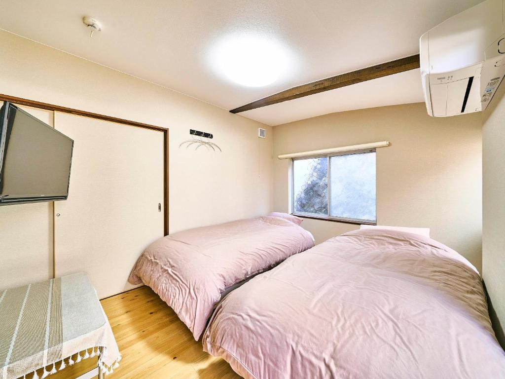 Postel nebo postele na pokoji v ubytování Kokoyui Guesthouse Shingu