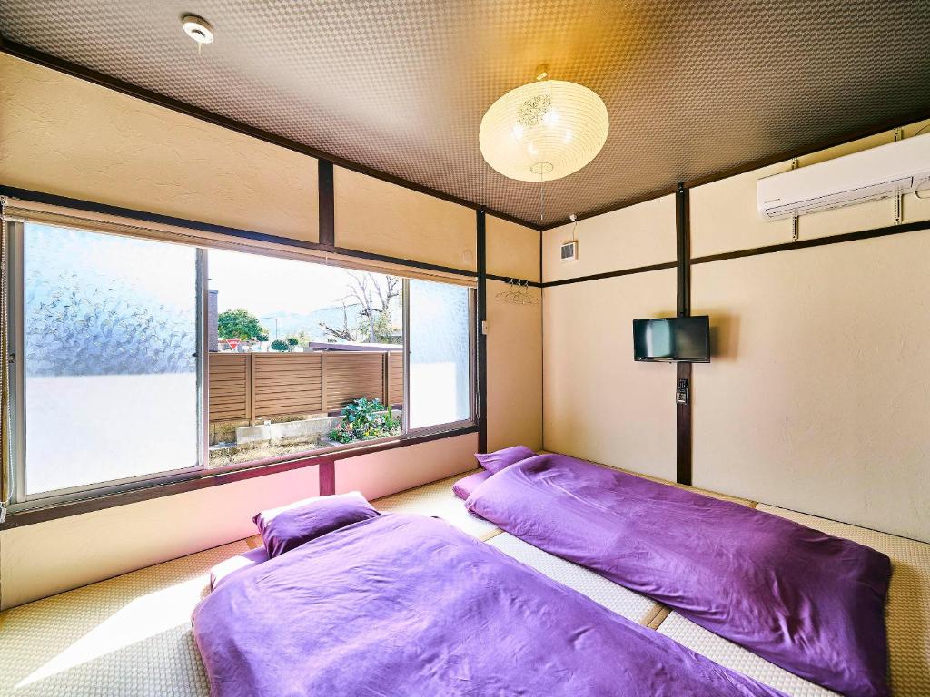 Postel nebo postele na pokoji v ubytování Kokoyui Guesthouse Shingu