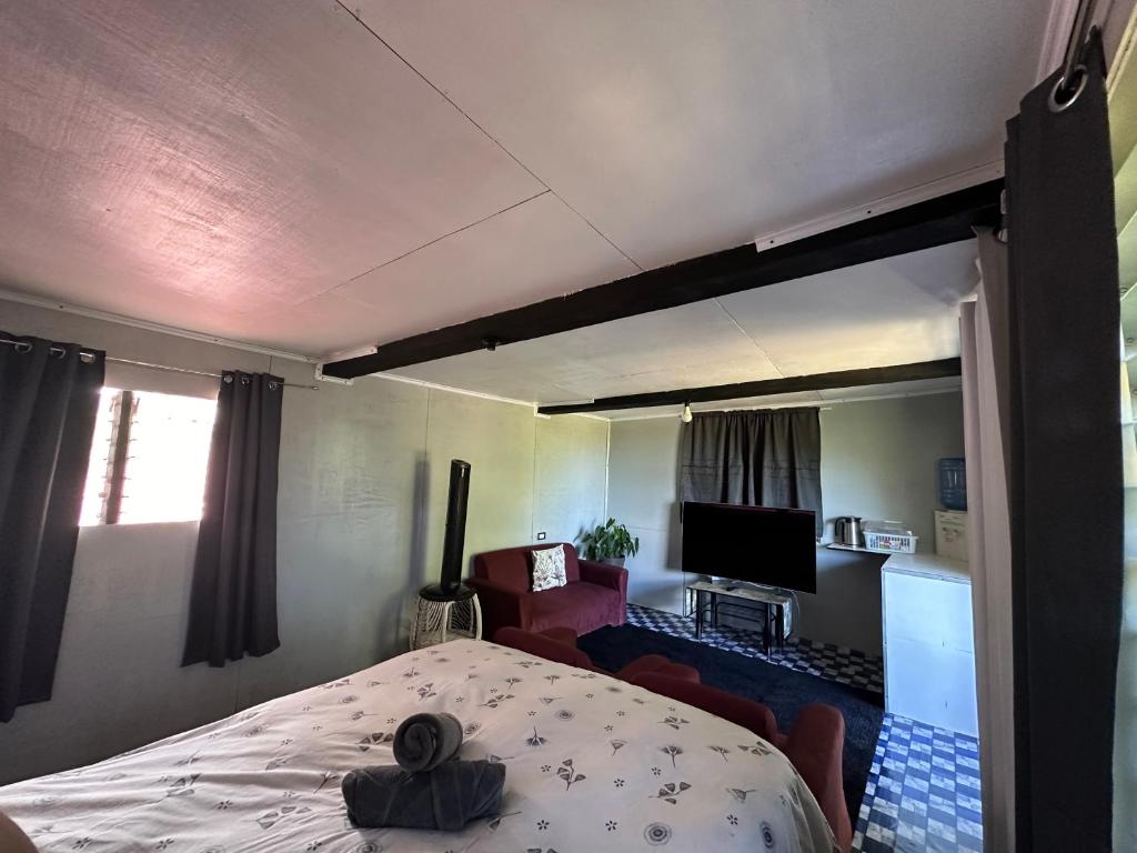 a bedroom with a bed and a tv in a room at John and Agnes Nicol 