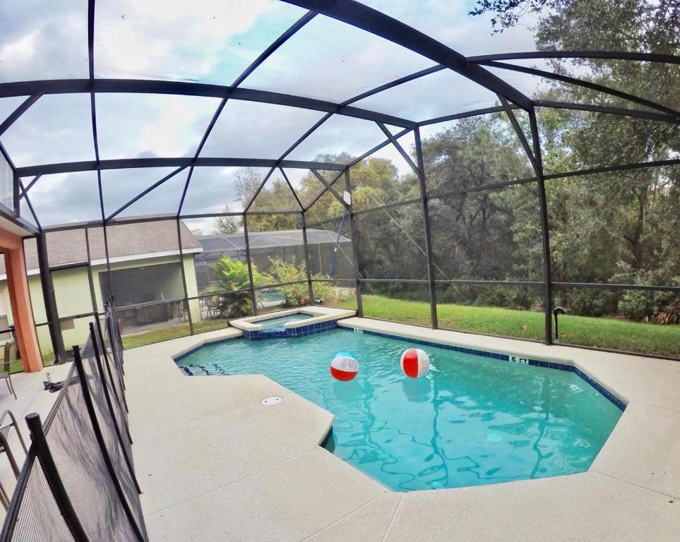 a swimming pool with a glass igloo at Panoramic 4BR Superior Pool Home near Disney Parks in Davenport
