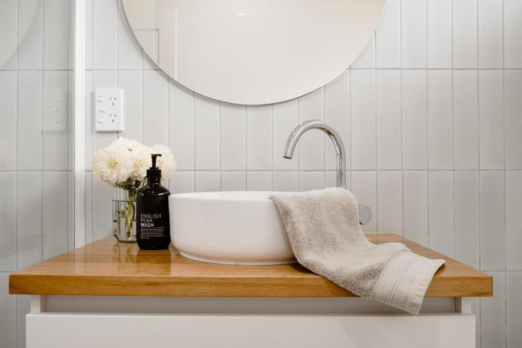 a bathroom with a sink and a mirror at Banksia Beach House in Port Fairy