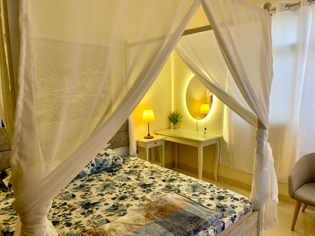 a bedroom with a bed with a canopy at Studio Appartment in Building in Ras al Khaimah